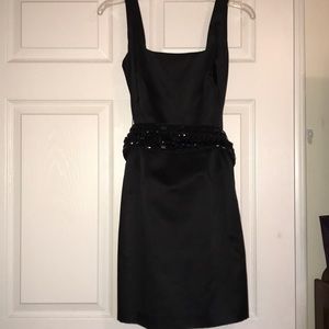 Black cocktail dress with beaded belt and bow